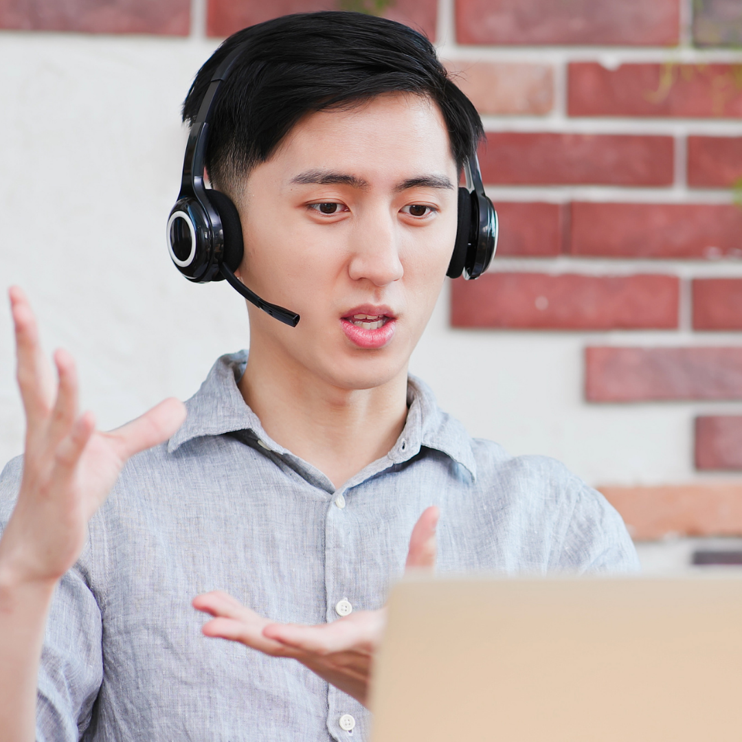 Professional man wearing headphone and speaking on video call. 