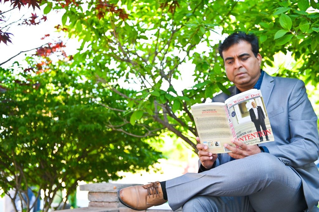 Dhaval Vediya, CM, reading a book in the park.