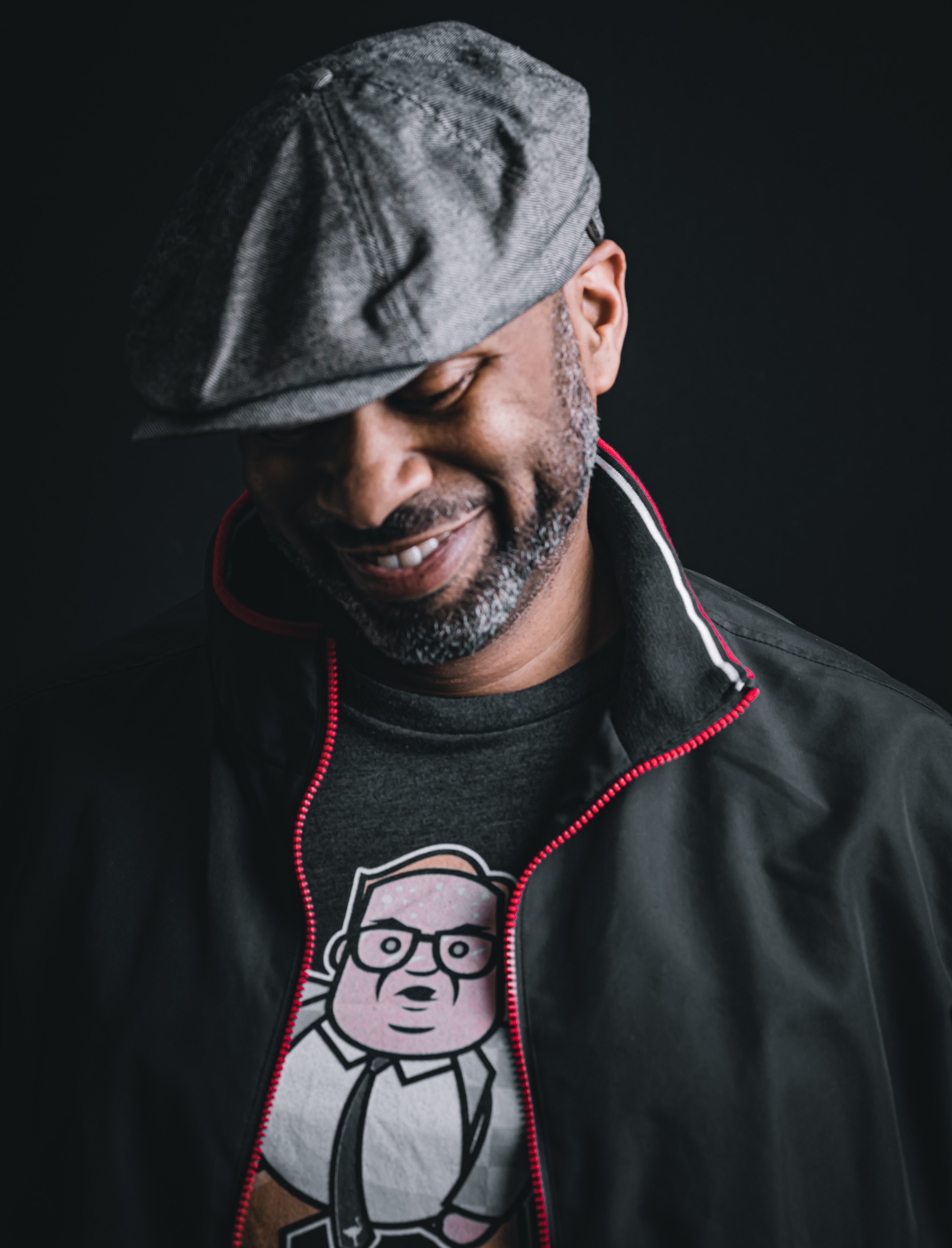 Headshot of Jason Egbuna, CM, smiling and looking down.