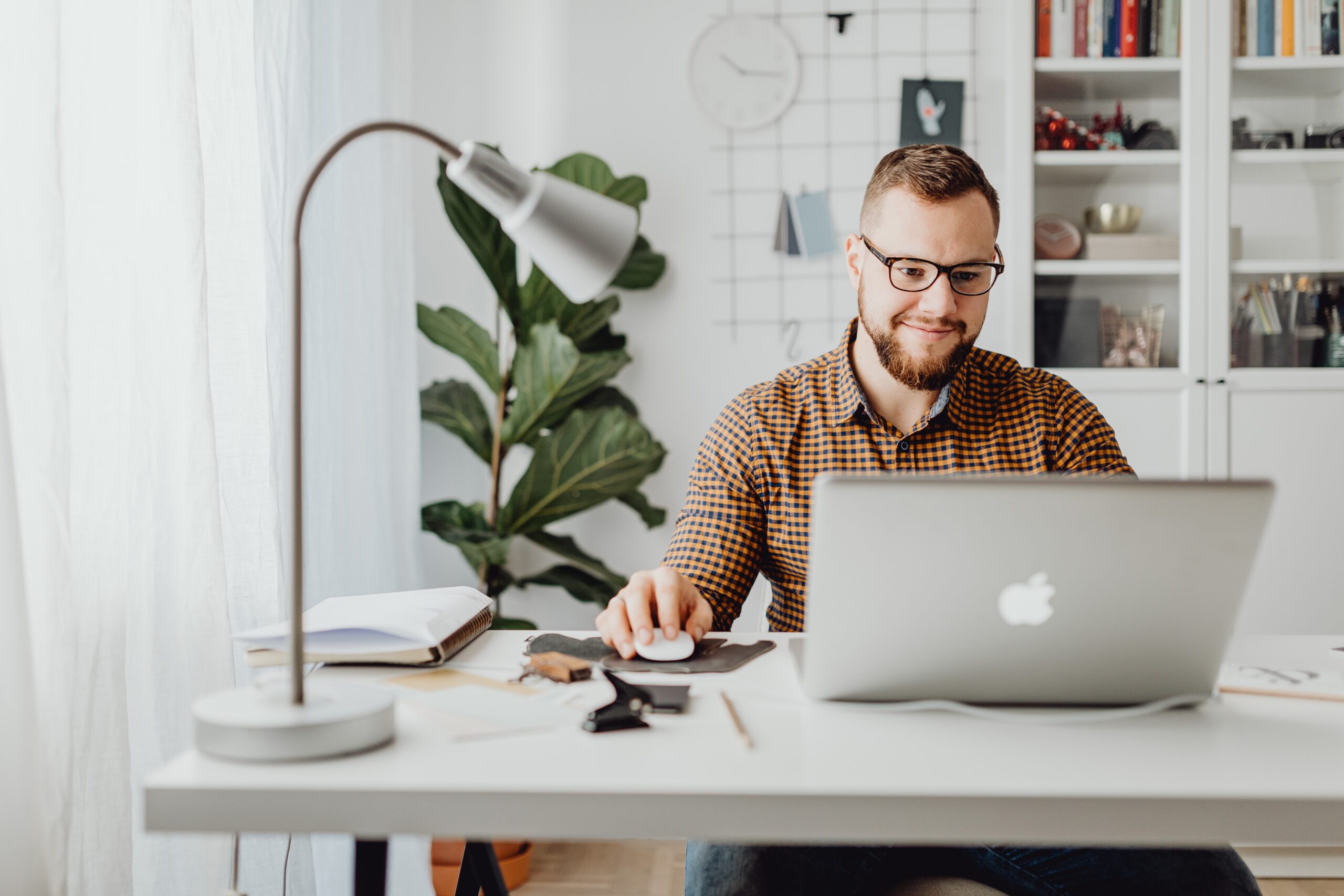 Marketer sitting at desk with laptop open.